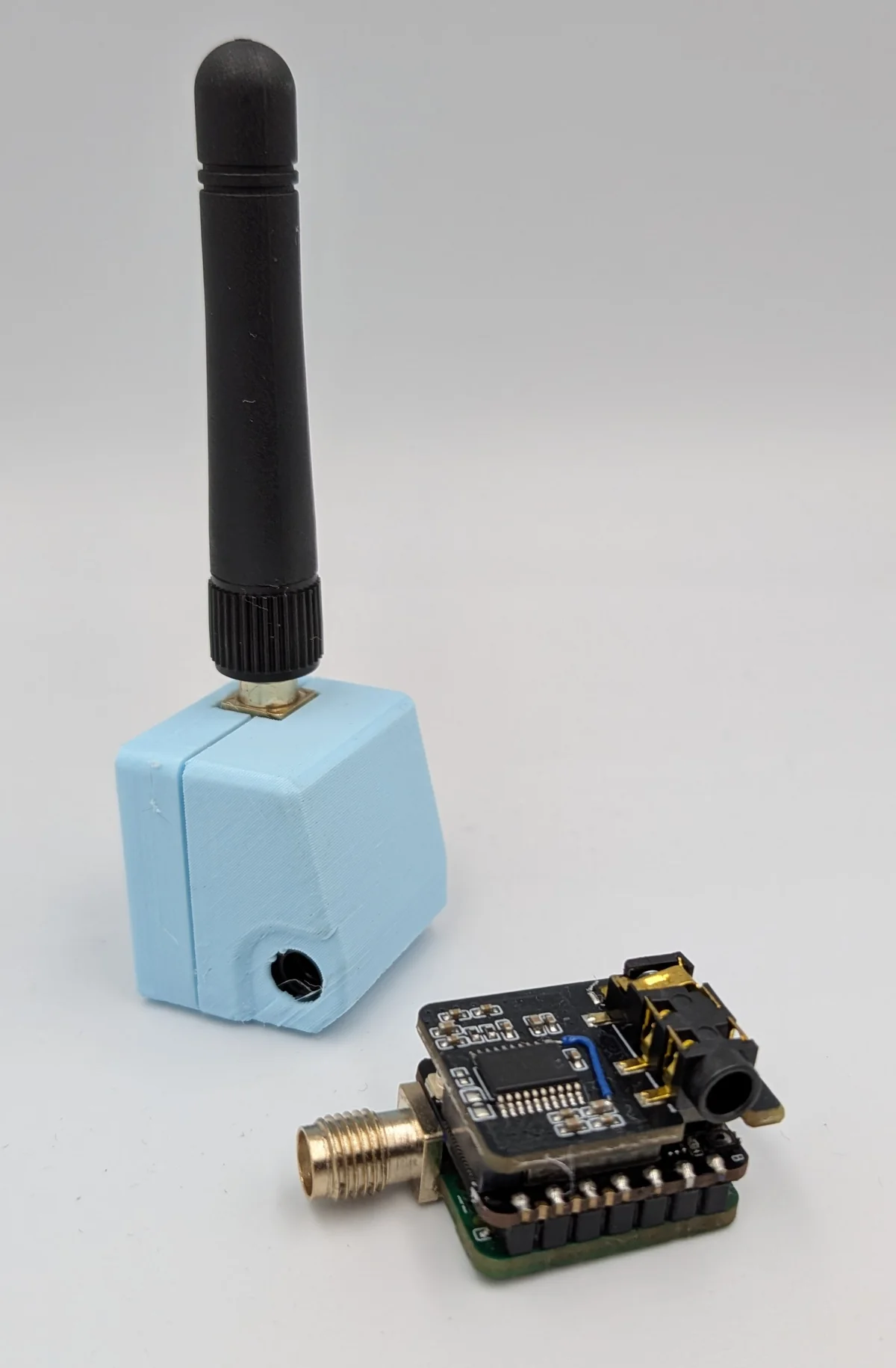 LongWave endpoint board beside a small blue enclosure with antenna